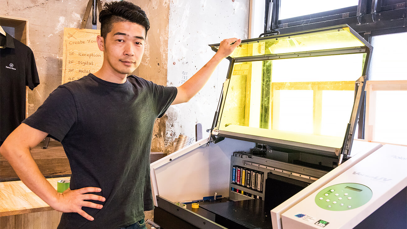 COO Junpei Matsuda with Roland DG’s UV printer, a permanent fixture at Makers’ Base Tokyo