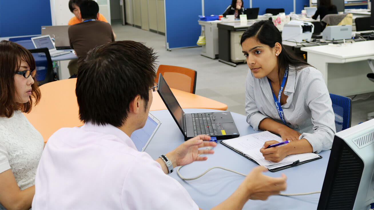 Anika consulting with members of her team