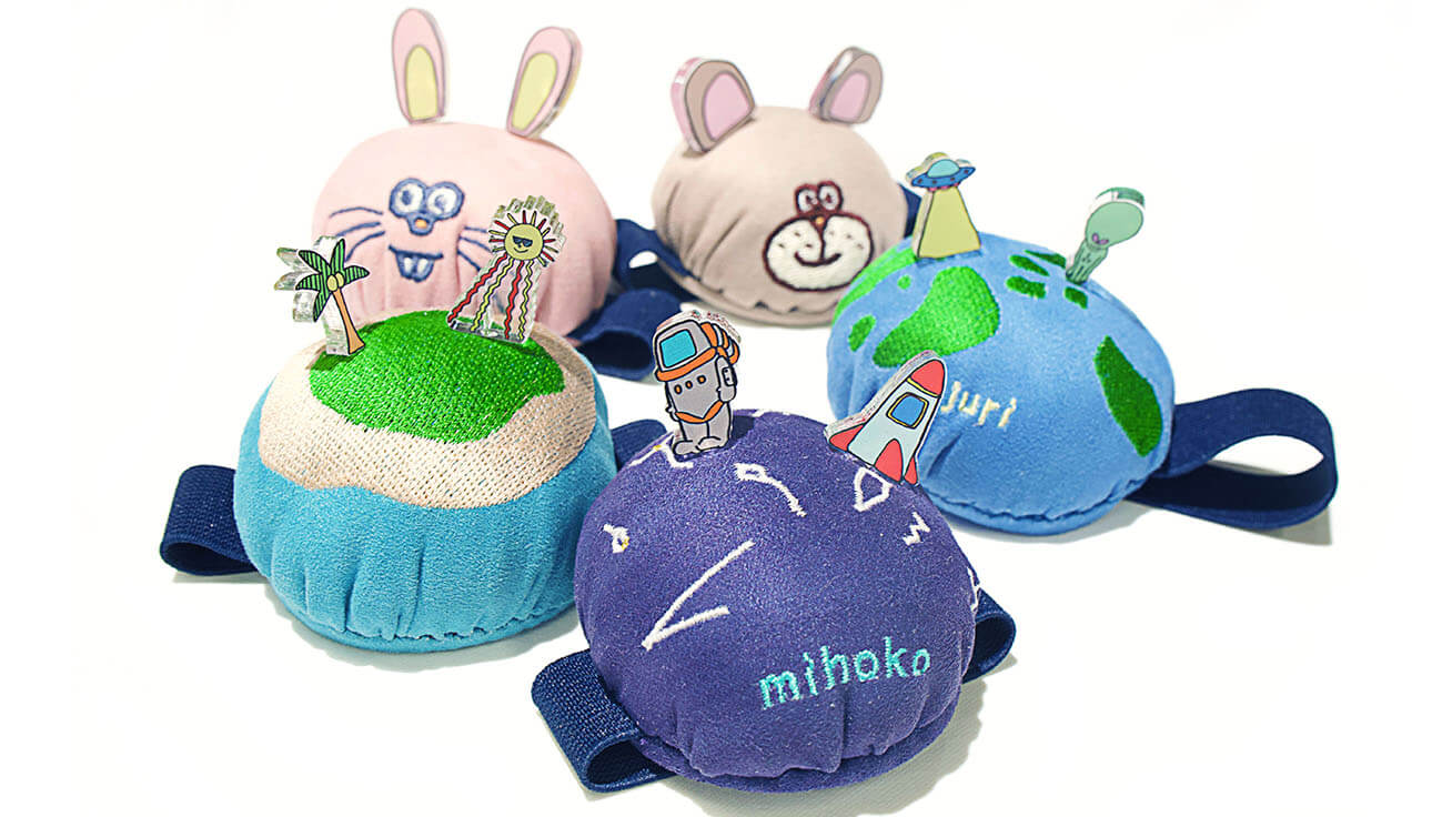 andMade one-of-a-kind pincushions featuring illustrations drawn by staff that were printed on pins with the UV printer, and onto cushions using an embroidery machine.