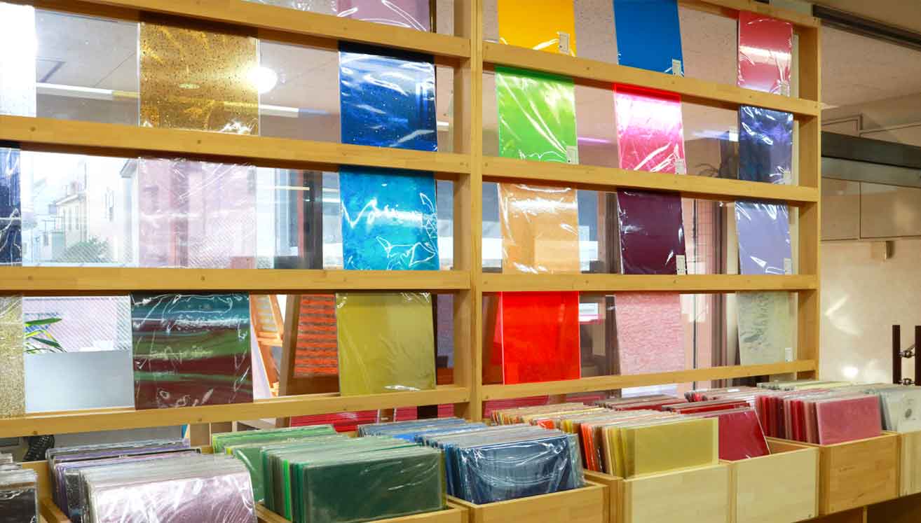 The showroom features acrylic sheets lined up like a record store.