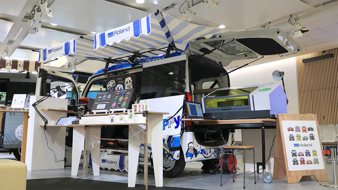 The custom van loaded with UV printers and other tools is displayed at various locations as a workshop or pop-up booth so visitors can create their very own accessories.