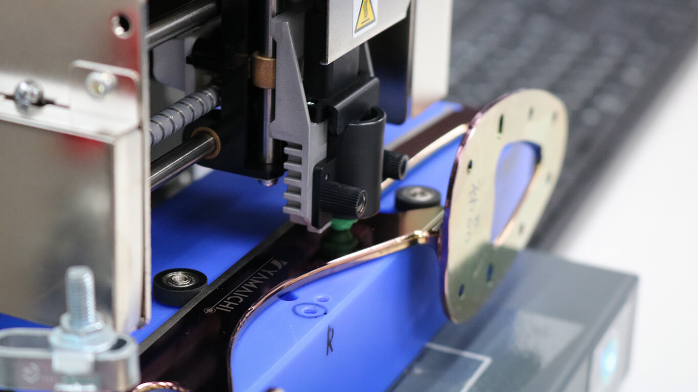 A photo impact printer strikes the blade surface to imprint logos.