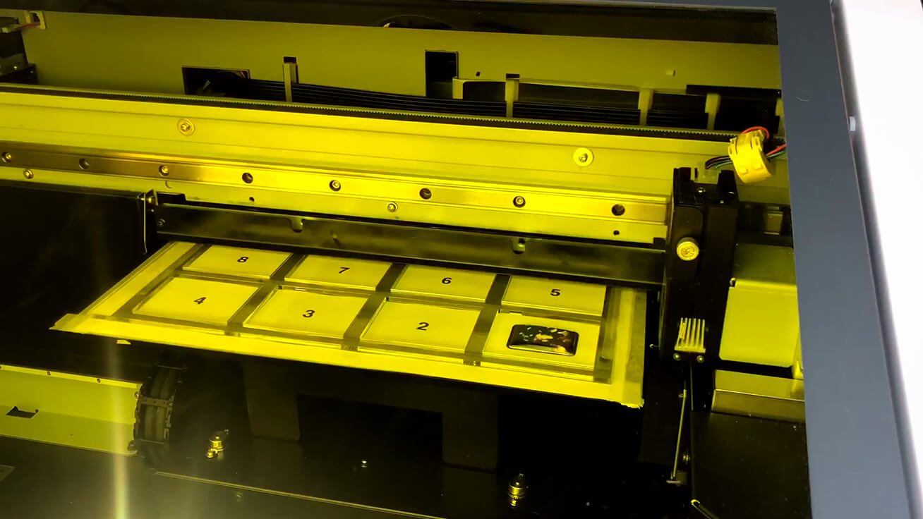 The LEF-12i UV printer customizing a MAMORIO FUDA with photos.