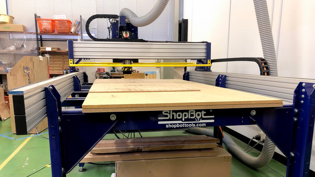 A large CNC router, rare in Kyushu, being used to machine wood sheets.