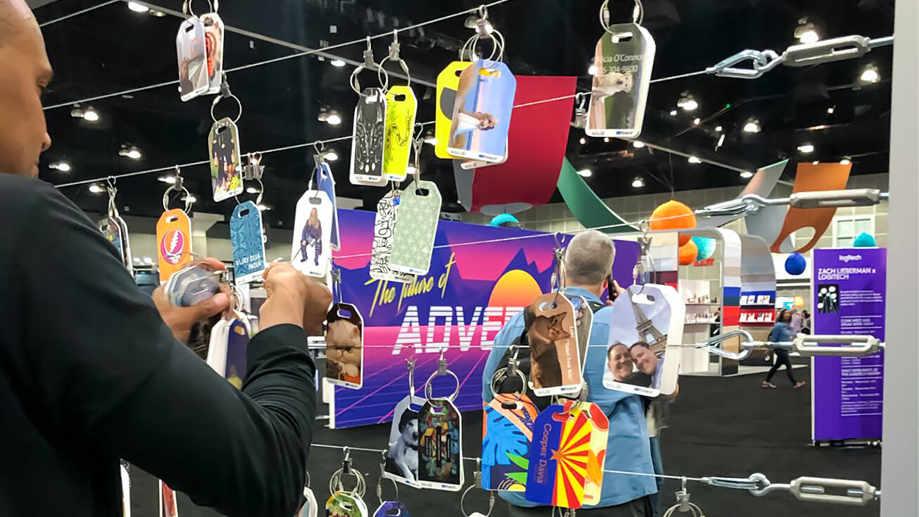 An Adobe MAX representative, adding new luggage tag designs to the mix of brilliant designs on display.