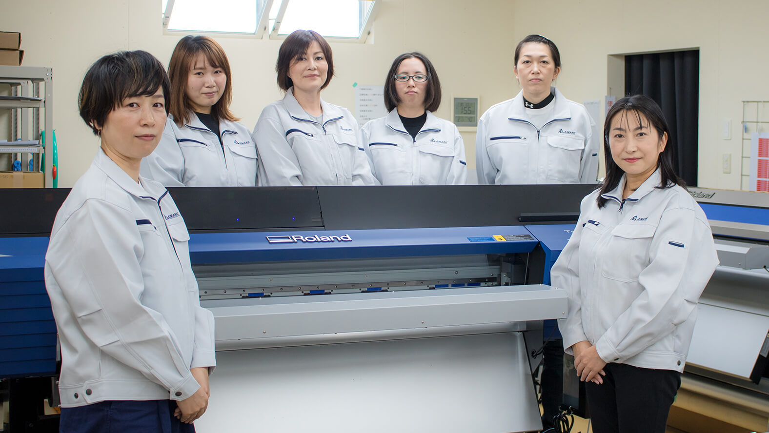 AIMARK President Seiko Kayakabe (front right), Shiho Fujiwara (front left) who is in charge of printing operations and staff members