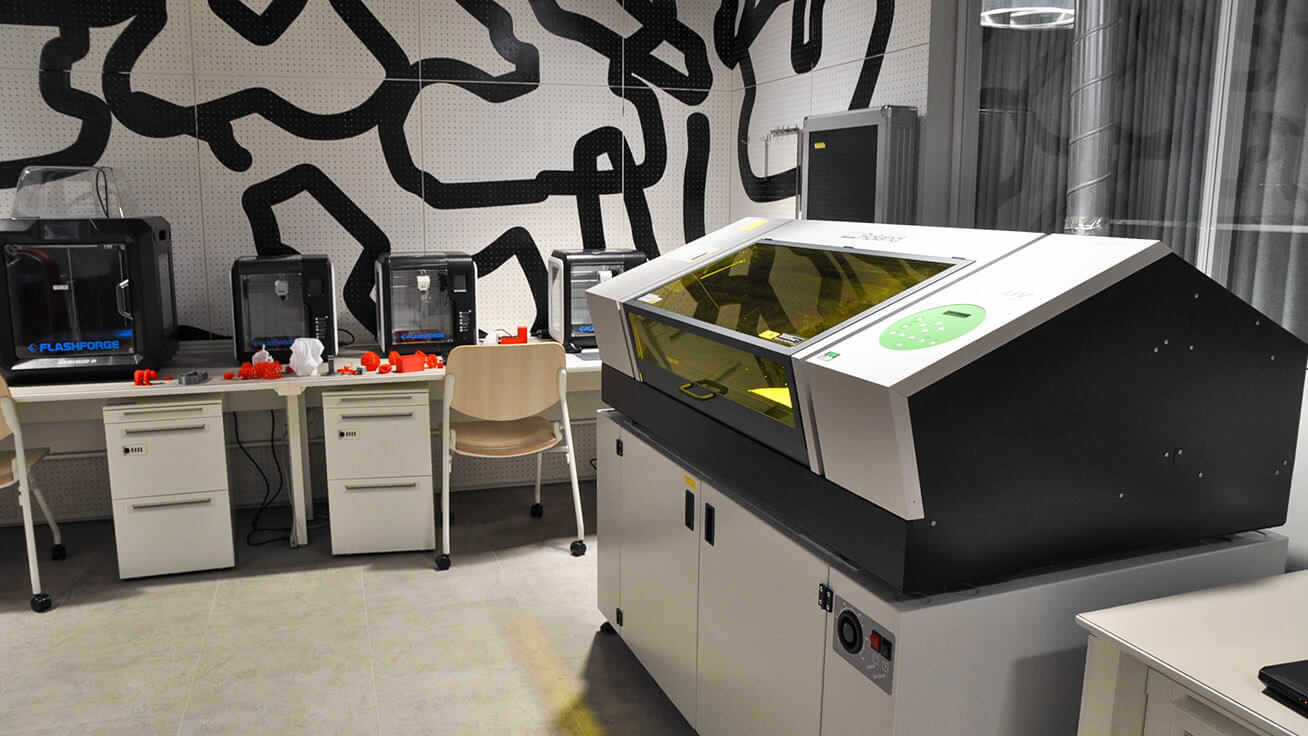 The VersaUV LEF-300 UV printer is available for use in the work area.