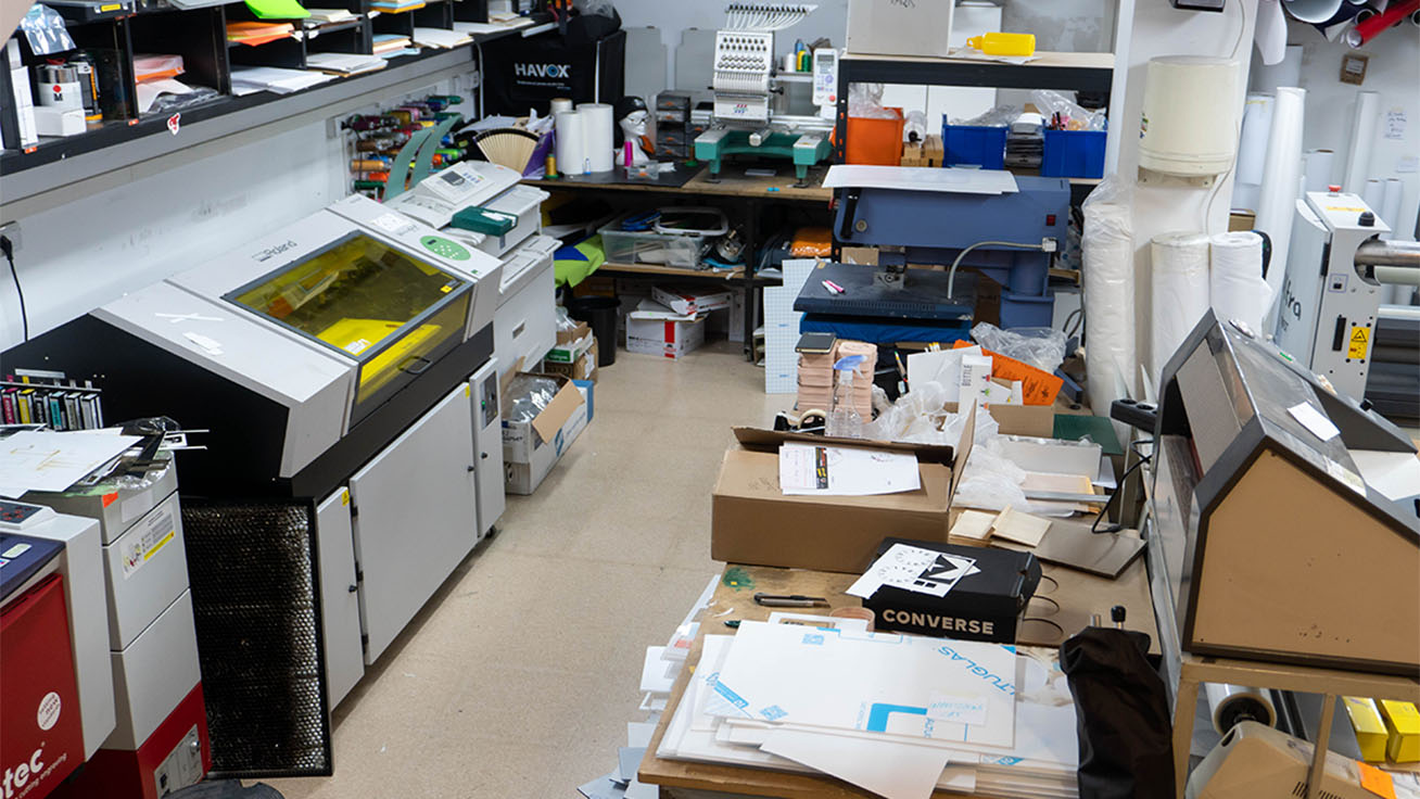 An underground workshop at the store houses the necessary equipment for customization, including the LEF-300 UV printer (left), a laser cutter and an embroidery machine.