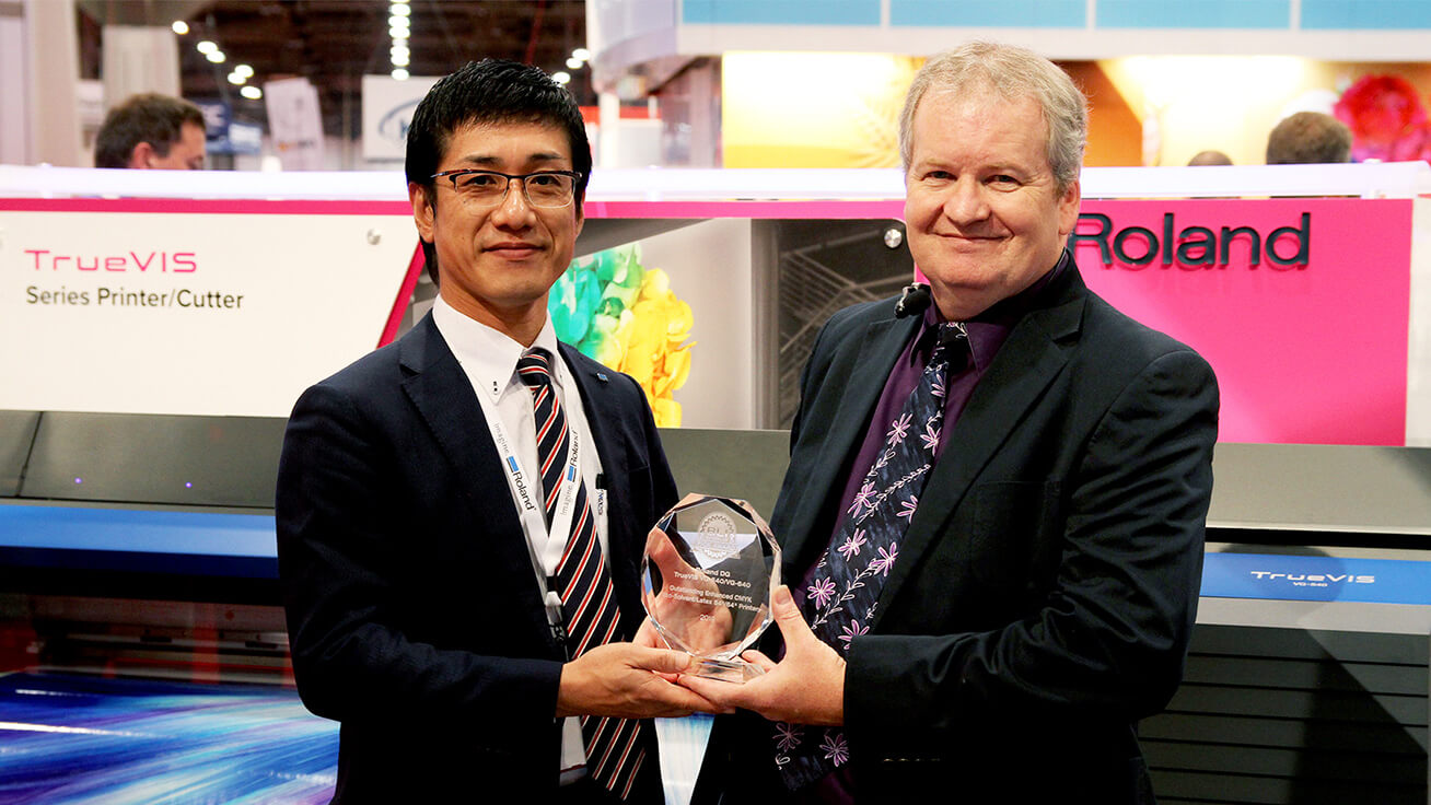 Kohei Tanabe, President, Digital Printing Business Division of Roland DG receives the award on behalf of Roland DG.
