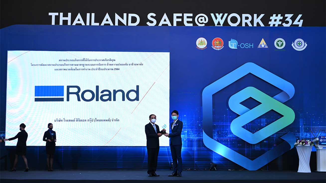タイのプラユット・チャンオチャ首相から盾を授与されるRoland Digital Group (Thailand) Ltd. 社長の山下基